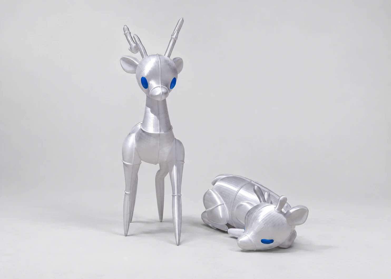 Standing and reclining translucent reindeer forms photographed together