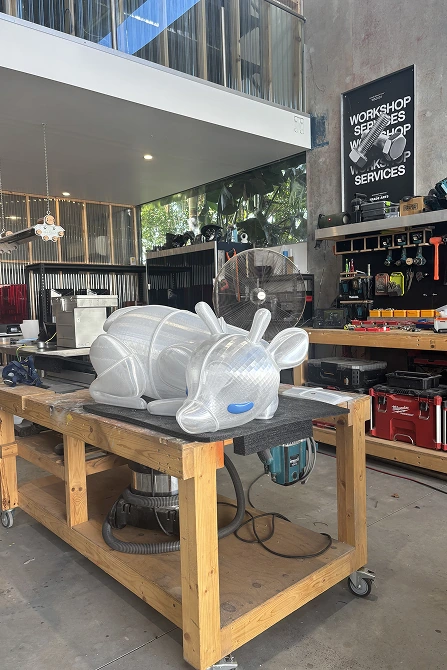 Reclining translucent reindeer on a timber workbench