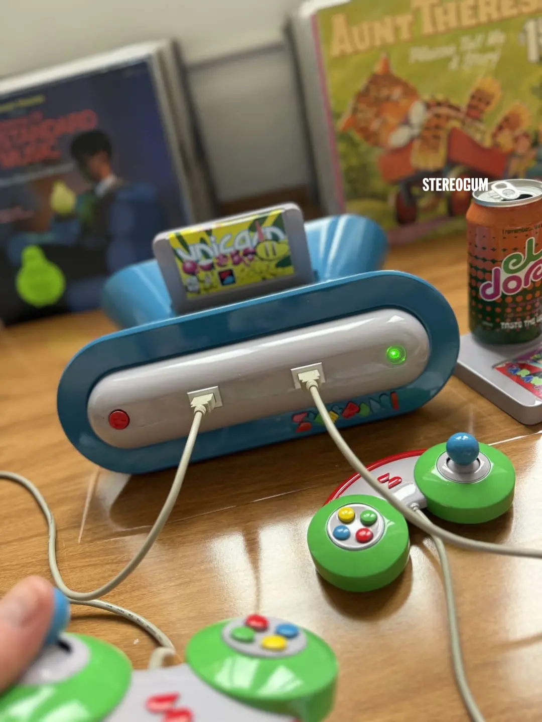 Finished blue Superfun console with green controllers and a game cartridge